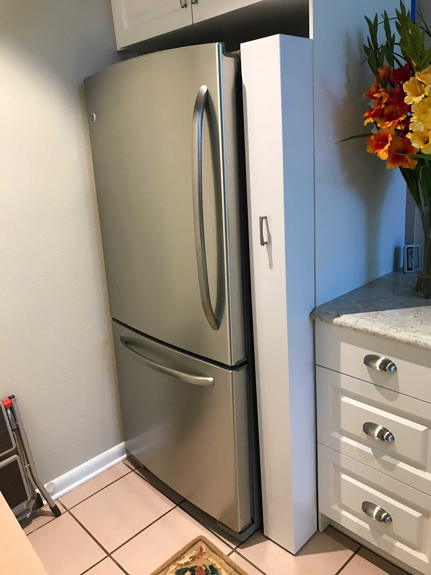 Custom sliding device fitting perfectly between the side of the fridge and counter