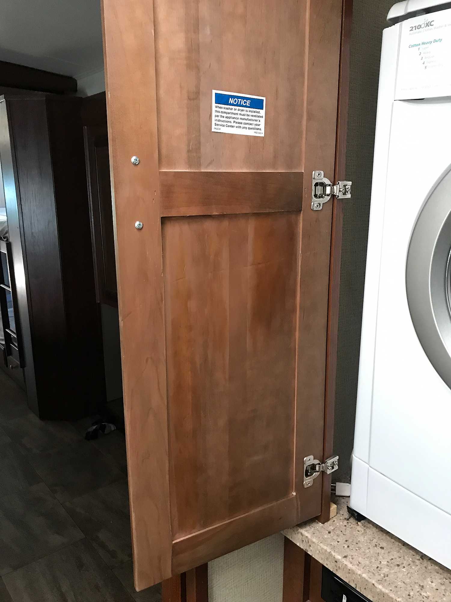 A brown cabinet door that suffered a violent break now looks like new